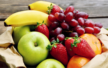 5 kind fresh  fruits in brown paper bag.
Mixed and colorful of fruits