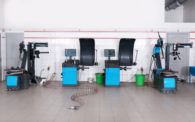 Car service center interior with modern tire fitting and wheel balancing equipment