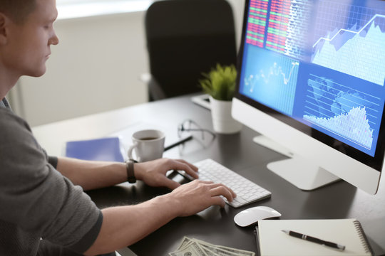 Man working with computer in office. Forex concept