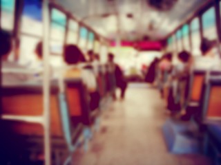 Abstract blurred image background of people on the bus at the morning in Thailand. view from inside with passengers of Bangkok. vintage and film tone effect.