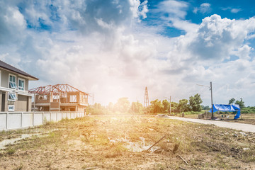 Obraz premium Residential new house building at construction site with clouds and blue sky