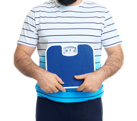 Overweight man with scale on white background
