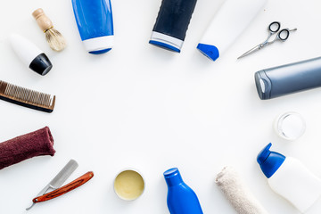 Cosmetics for men's hair. Bottles with shampoo and gel, tools for brushing, sciccors on white background top view copy space