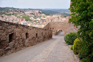 Fototapeta premium Entrance of Cardona Castle. Stone walls and road.
