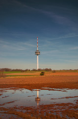 Obraz premium View of a Radio mast and tower with landscape field view. Fernmeldeturm Broitzem in Braunschweig, Germany