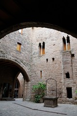 Fototapeta na wymiar Courtyard of Cardona Castle. Stone walls and medieval well.