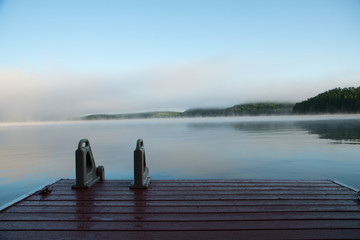 Muskoka dock on a misty morning lake