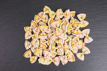 heap of multicolored raw pasta farfalle