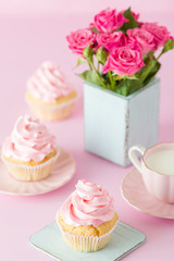 Pink pastel vertical banner with decorated cupcakes, cup of coffe with milk and bouquet of pink roses.