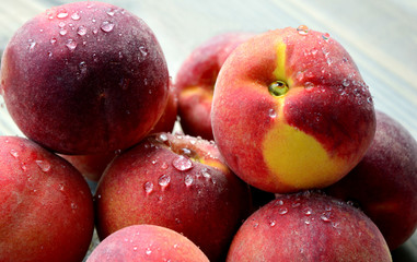 Many Fresh Peach with water drops and shadow on wooden background