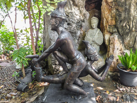 Bangkok, Thailand - Circa January 2018: Statues depicting a Thai Massage (Nuad Boran) move at the famous Wat Pho (Buddhist Temple)