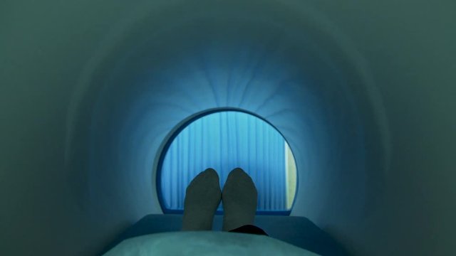 A patient moving into mri scan machine