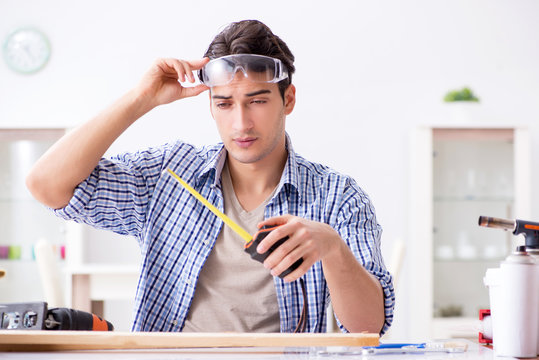Young man in woodworking hobby concept