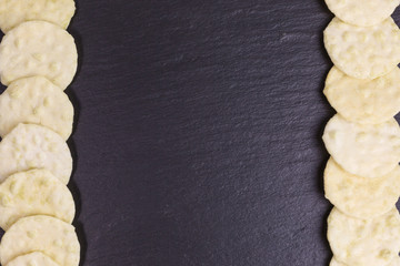 wasabi rice cracker on slate plate with copy space