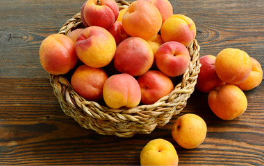 Fresh Apricot in the basket on wooden background