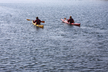 Kayak rowers on a kayak paddling by the sea, active water sport and leisure, kayaking