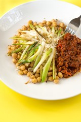 Chickpeas, onion shoots and chilli tofu on plate.