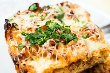 Gratinated pasta, isolated on white.