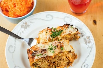 Baked pasta, carrot salad and drink.