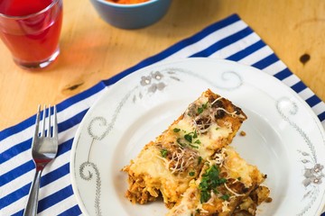 Gratinated pasta, drink.