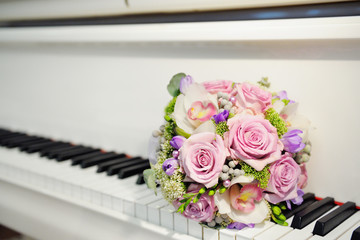 Bouquet of a bride on the piano keys. Beautiful wedding bouquet.