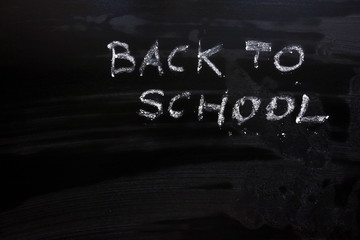 Text back to school on chalkboard, education background concept, copy space for your design