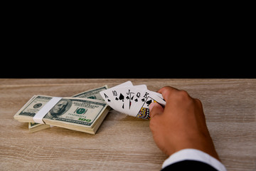 Gambling Concepts. Businessmen are gambling in the casino. Betting is a gamble for investors. Businessmen are playing card games on a black background.