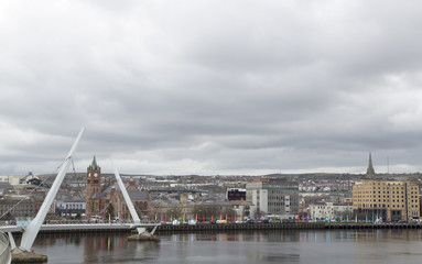 The Peace Bridge over the river Foyle and Guildhall, Derry/Londonderry, Northern Ireland