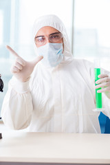 Young chemist pressing virtual buttons in lab
