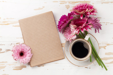 Coffee cup and gerbera flowers