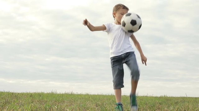One happy little boy playing football. Concept of sport.