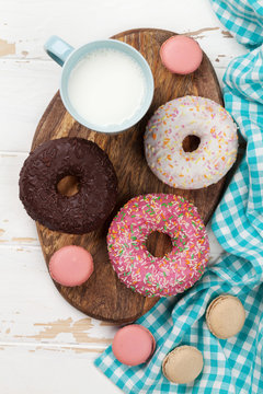 Milk and donuts on wooden table