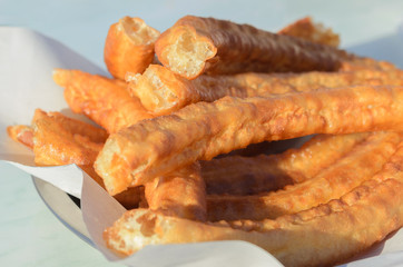 Close up of churros, typical Spanish snack like  is a fried-dough pastry. Churros is a classic Spanish breakfast consumed with hot chocolate or coffee with milk