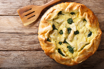 Sliced pie with artichokes, cheese and spinach close-up. horizontal top view