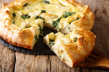 Golden organic healthy crispy pie with artichokes, cheese and spinach close-up. horizontal