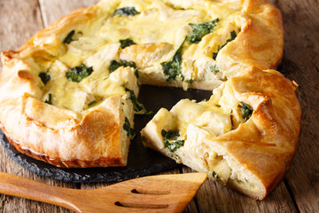tasty pie with artichokes and spinach close-up. horizontal