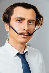 eccentric man with a long mustache in his shirt and tie. A mad office worker, a businessman