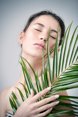 Fototapeta premium woman with tropical leaf
