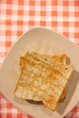 Honey bread on tablecloth background . Top view.