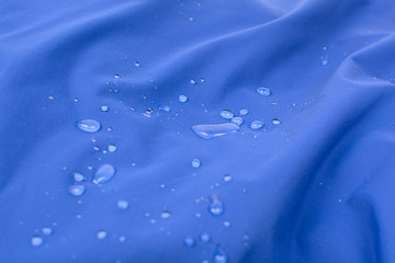 Water repellent coating durable repellency fabric outdoor shell jacket with water drops. Waterproof membrane with droplets.