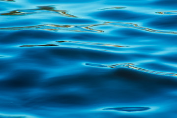 Blurred sea water texture close up - blue background
