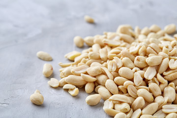 Pile of peelled peanuts isolated on white textured background, background, top view, close-up, selective focus
