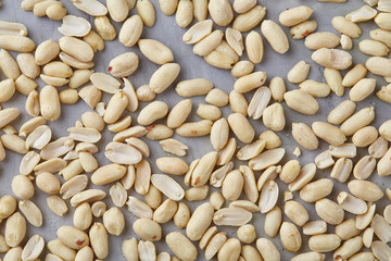 Pile of peelled peanuts isolated on white textured background, background, top view, close-up, selective focus