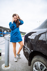 woman stand near scratched auto. call for help. car insurance