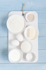 Ingredients for baking on the textured blue wooden table