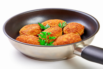 Cooked fried cutlets in pan isolated on white background