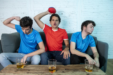 disappointed and happy football fans watching a football match