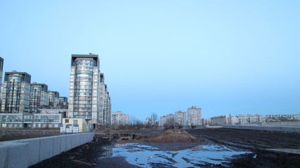 Naklejka premium Evening city quarter on the river bank