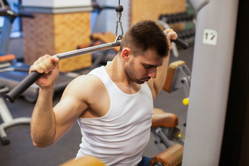 man with weight training in gym equipment sport club