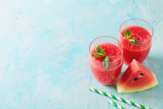 Watermelon smoothie with slice of fruit and leaf of mint